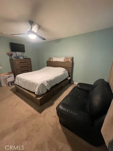 a bedroom with a bed window and a chair