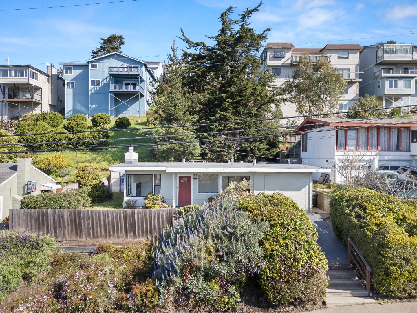 a view of a house with a yard and sitting area