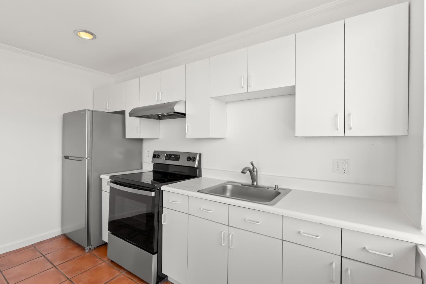 443 Monterey Road Pacifica, CA 94044 - Photo 11 of 26 a kitchen with stainless steel appliances white cabinets and a sink
