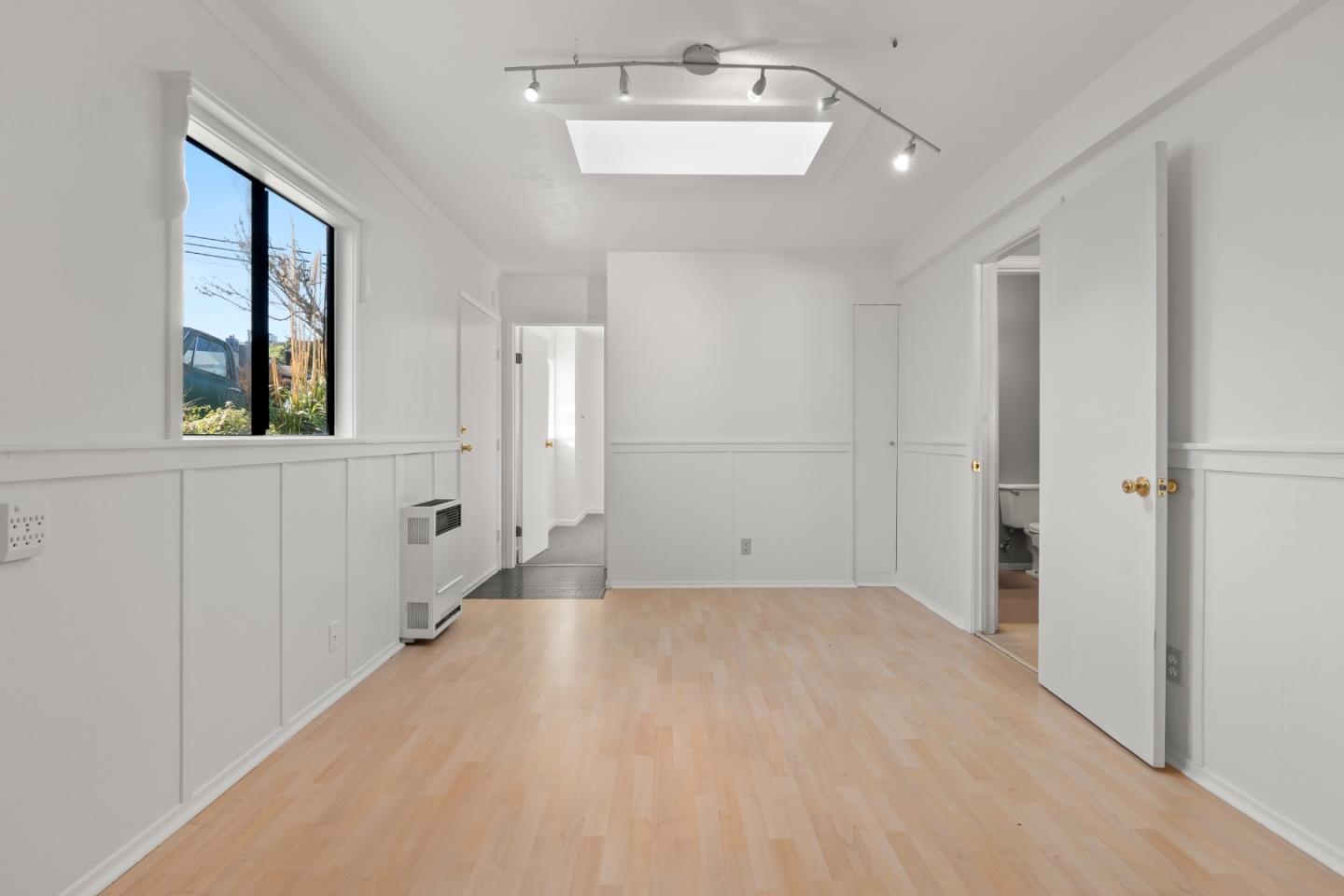 443 Monterey Road Pacifica, CA 94044 - Photo 17 of 26 wooden floor in an empty room with a window