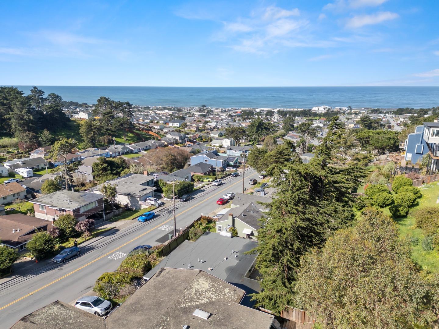 443 Monterey Road Pacifica, CA 94044 - Photo 23 of 26 an aerial view of a city with lots of residential buildings and ocean view in back