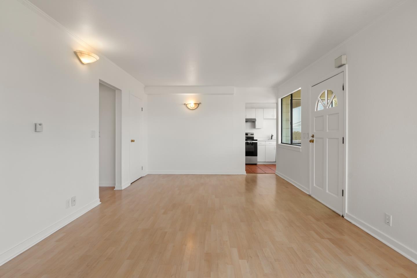443 Monterey Road Pacifica, CA 94044 - Photo 7 of 26 a view of a big room with wooden floor and windows