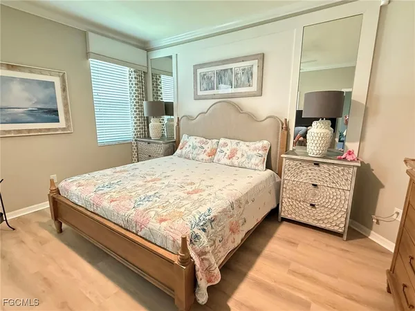 a large bed sitting in a bedroom next to a window