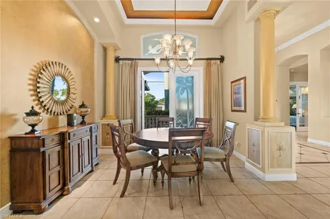 a view of a dining room with furniture and chandelier