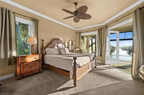 a living room with bed cabinet and a large window