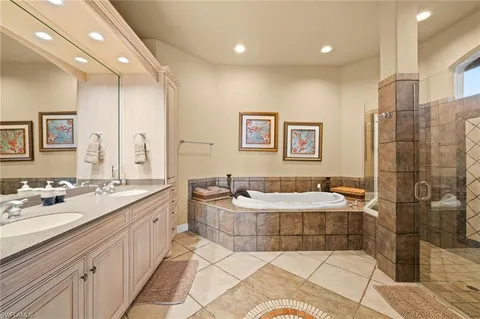 a bathroom with a double vanity sink mirror and shower