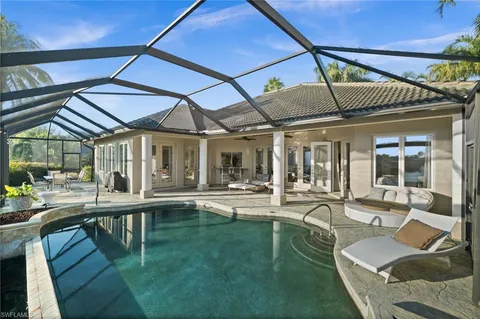 a swimming pool with outdoor seating and yard
