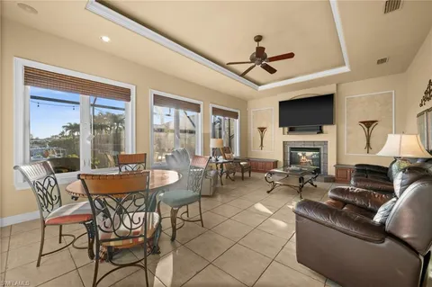 a dining room with furniture a flat screen tv and a fireplace