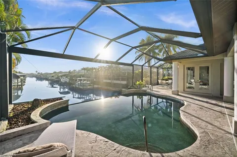 a view of a balcony with floor to ceiling windows and wooden floor