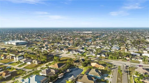 an aerial view of residential building and trees around