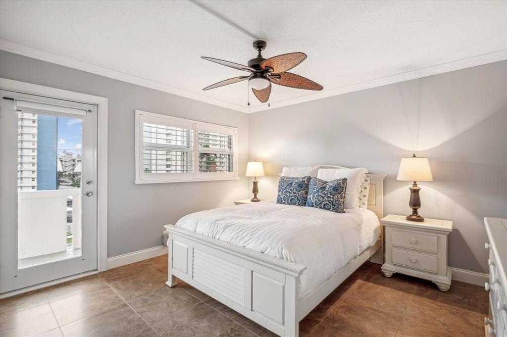 303 North Riverside Drive, Unit 403 Pompano Beach, FL 33062 - Photo 13 of 31 a bedroom with a bed and a window