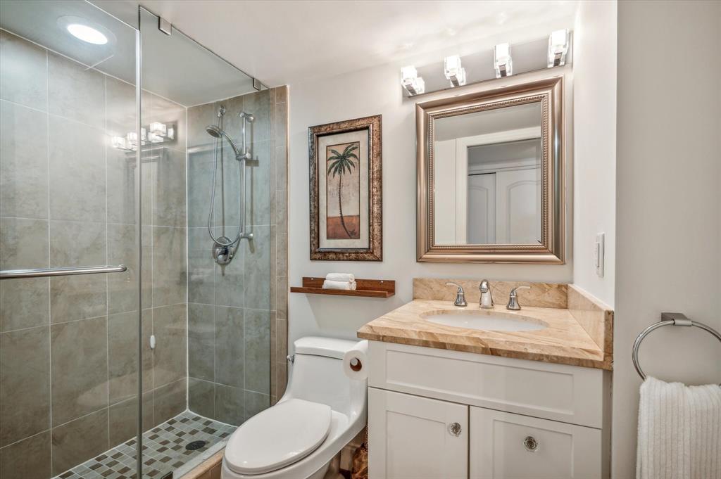 303 North Riverside Drive, Unit 403 Pompano Beach, FL 33062 - Photo 14 of 31 a bathroom with a granite countertop sink a toilet and shower