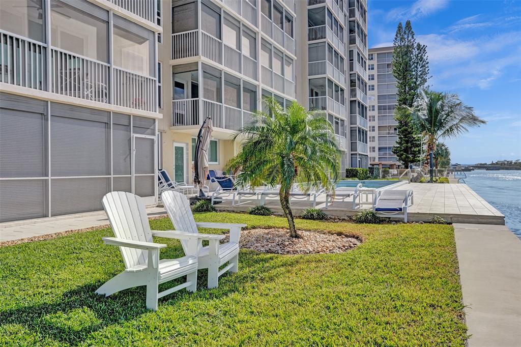 303 North Riverside Drive, Unit 403 Pompano Beach, FL 33062 - Photo 22 of 31 a view of a patio with table and chairs and potted plants