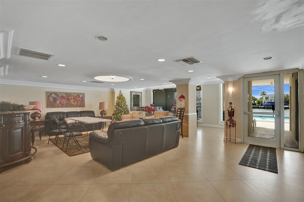 303 North Riverside Drive, Unit 403 Pompano Beach, FL 33062 - Photo 24 of 31 a living room with furniture and a view of kitchen