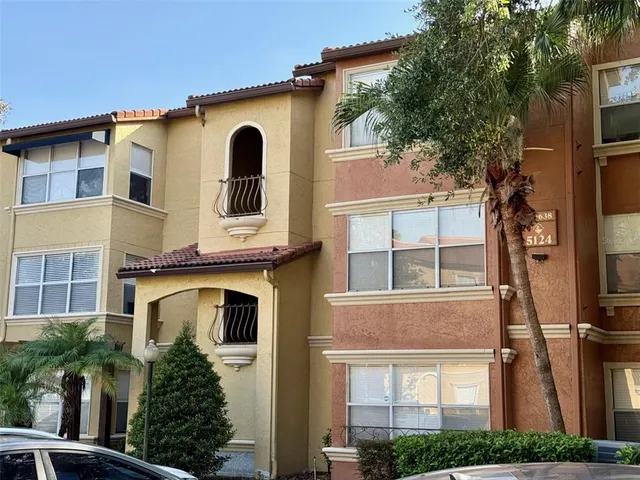 a kitchen with stainless steel appliances kitchen island granite countertop a refrigerator and a stove