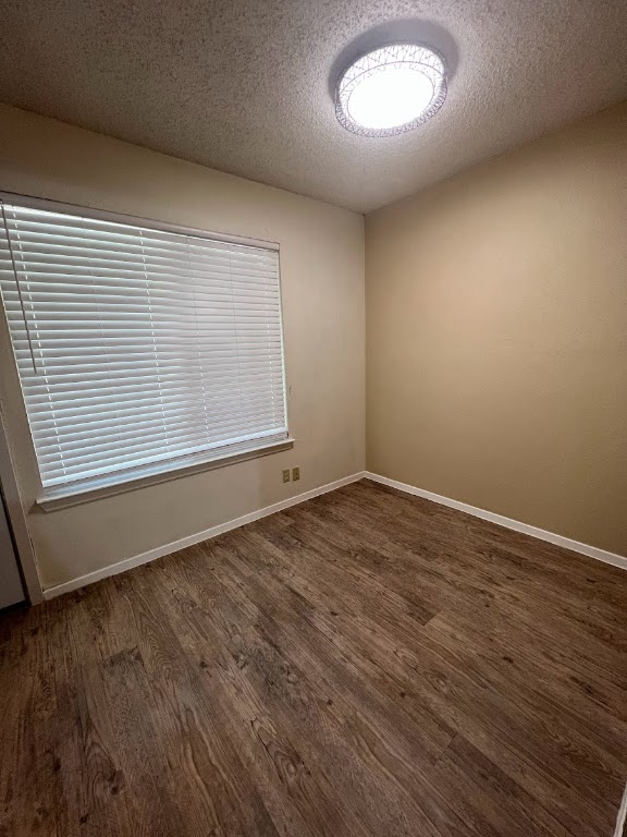 202 East 32nd Street, Unit 2 Austin, TX 78705 - Photo 8 of 22 an empty room with wooden floor and windows