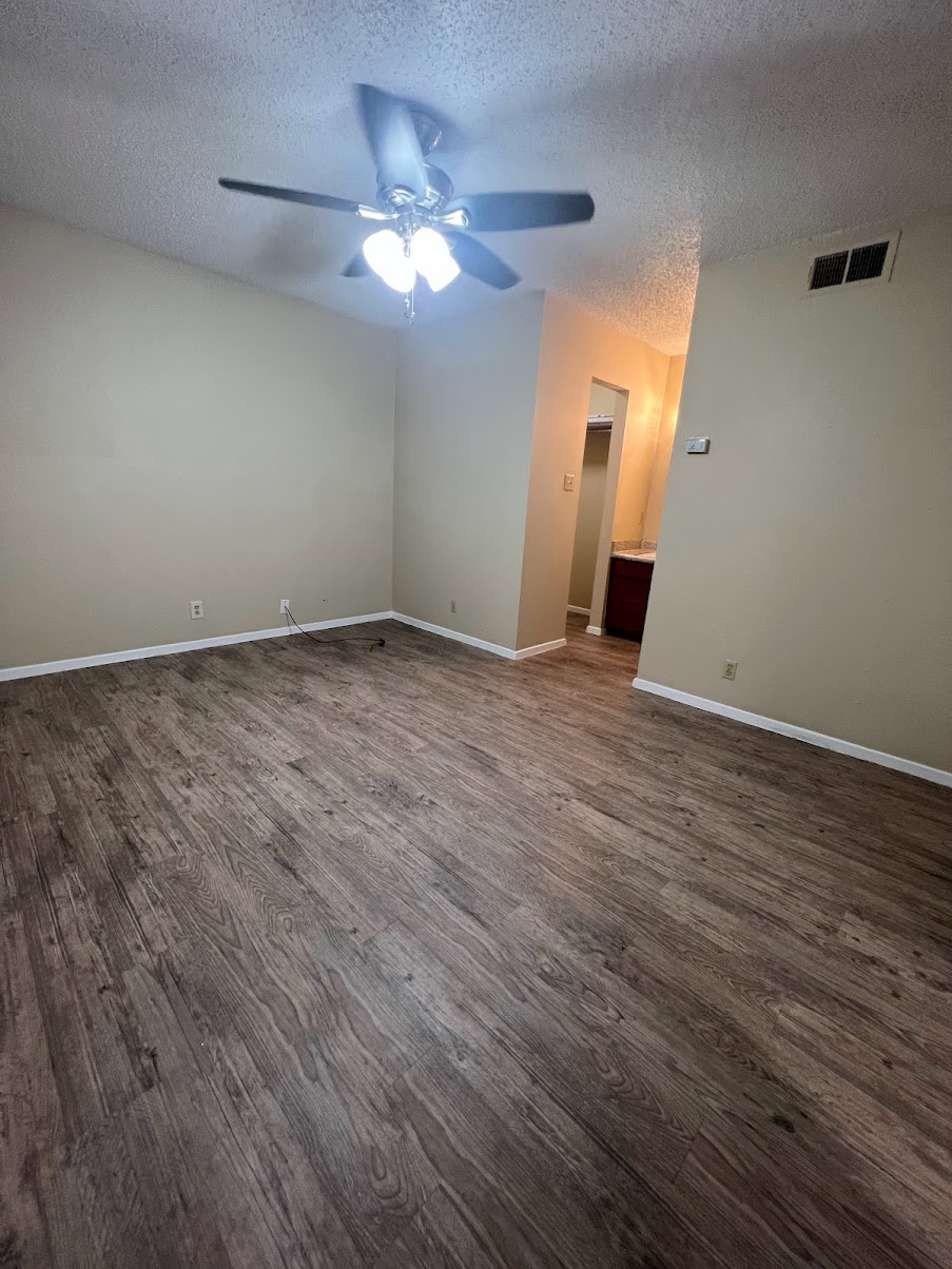 202 East 32nd Street, Unit 2 Austin, TX 78705 - Photo 10 of 22 a view of an empty room with wooden floor