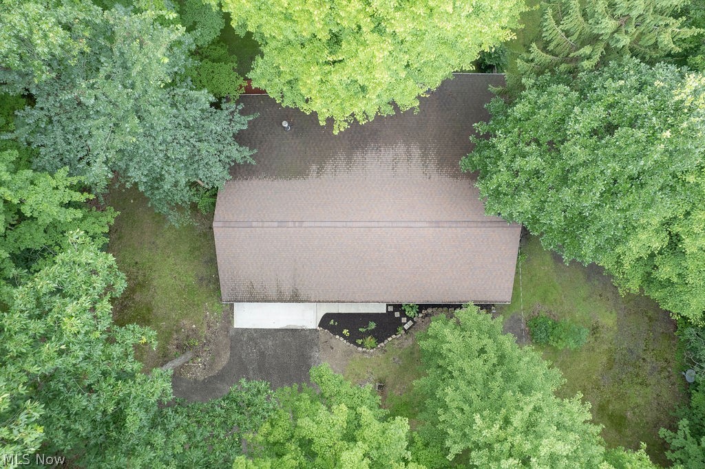 18620 Shaw Road Chagrin Falls, OH 44023 - Photo 37 of 44 Expansive property with a brown shingle roof, mature perimeter trees, and a concrete driveway