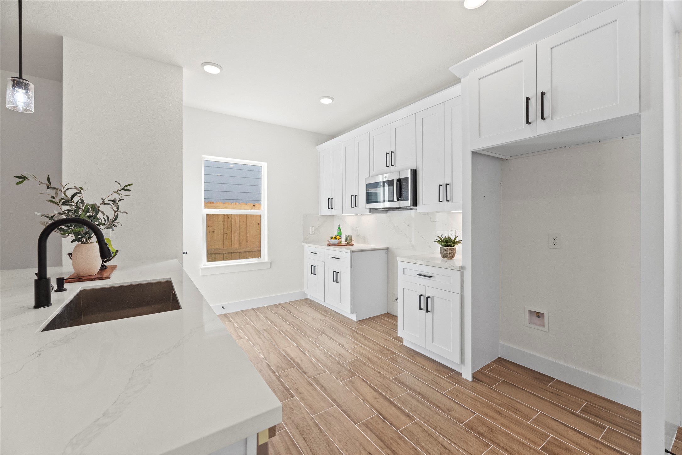 769 Marjorie Street Houston, TX 77088 - Photo 11 of 48 a kitchen with white cabinets and white appliances