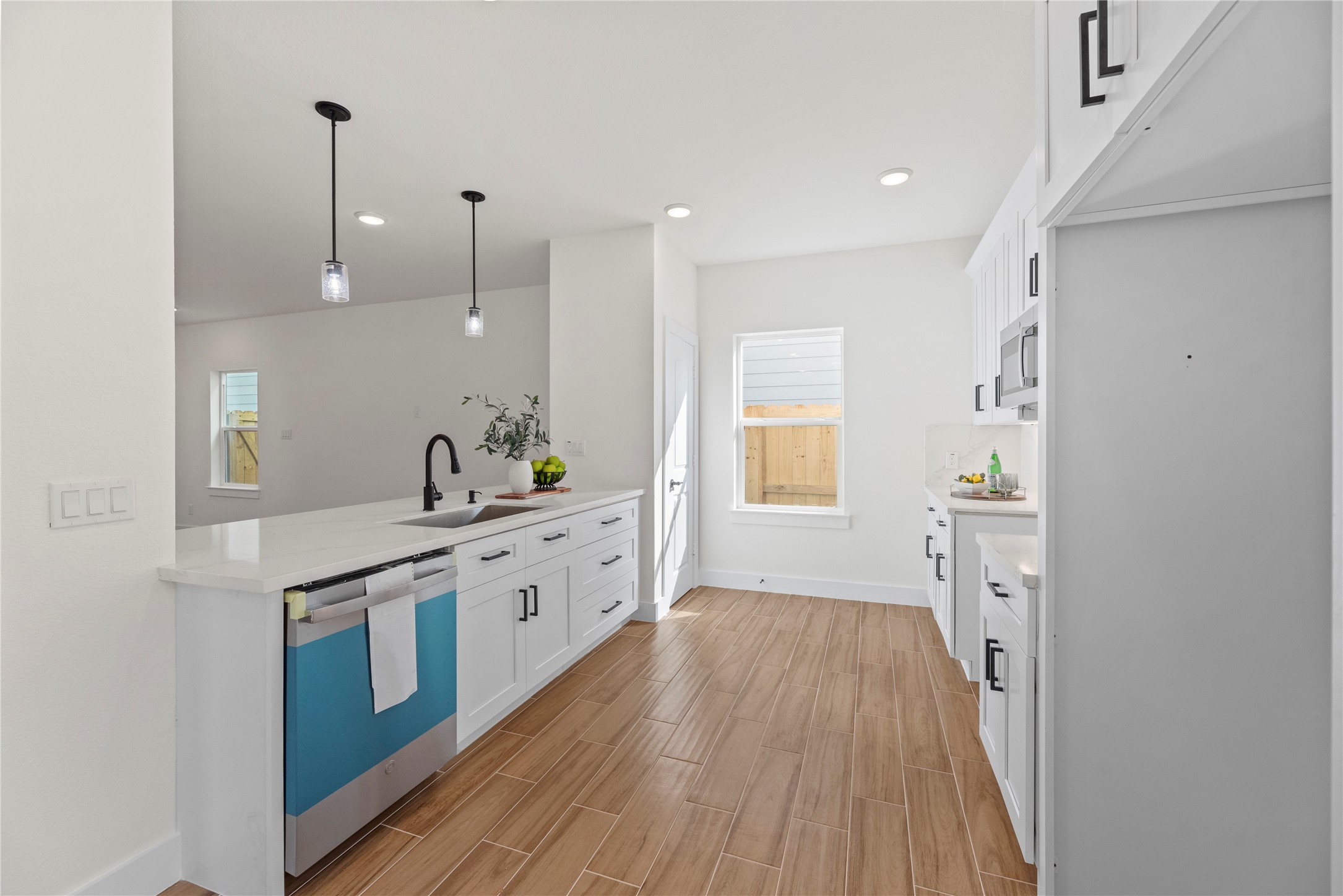 769 Marjorie Street Houston, TX 77088 - Photo 13 of 48 a large kitchen with a wooden floor and a sink