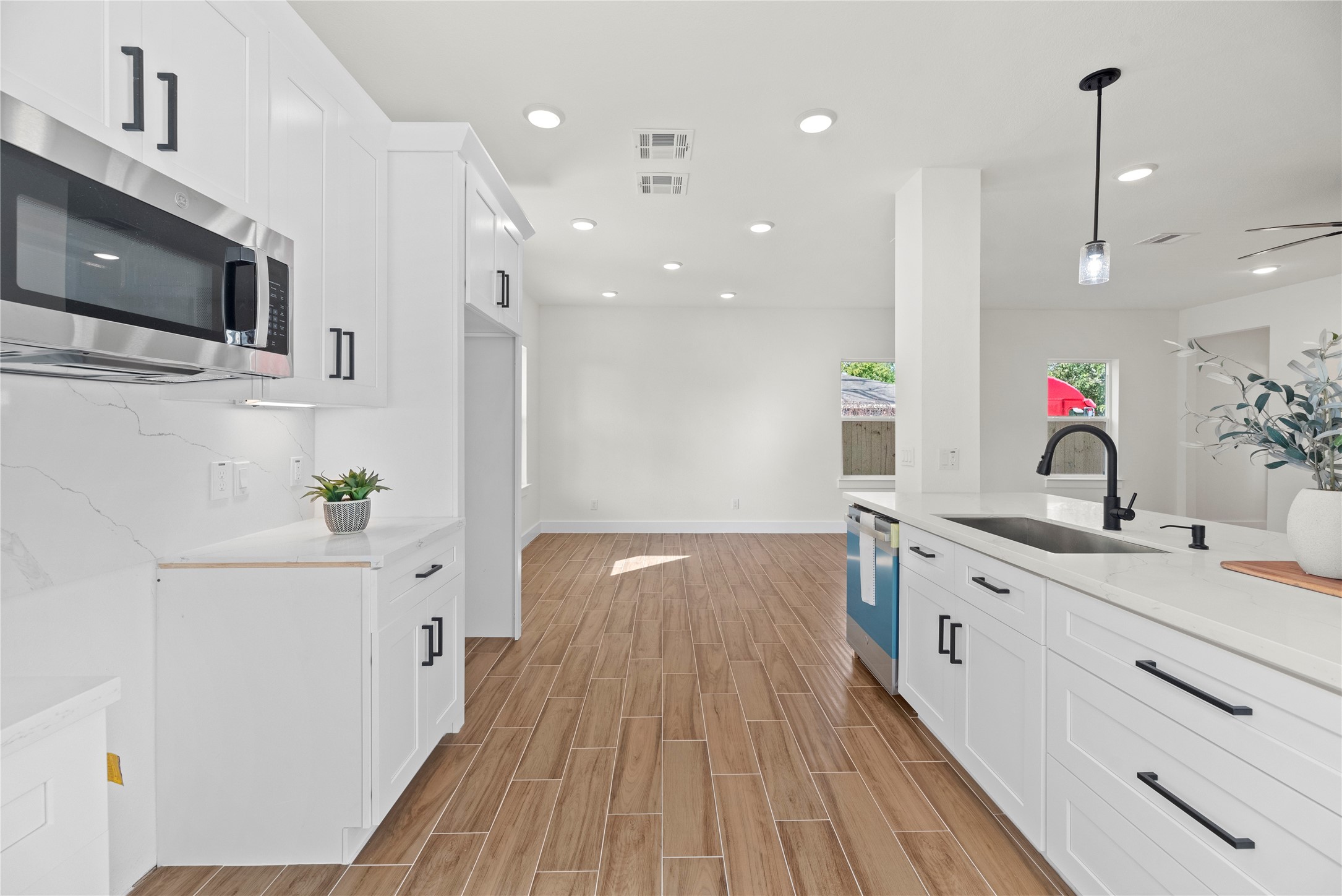 769 Marjorie Street Houston, TX 77088 - Photo 15 of 48 a view of a kitchen with kitchen island stainless steel appliances a sink and wooden floor