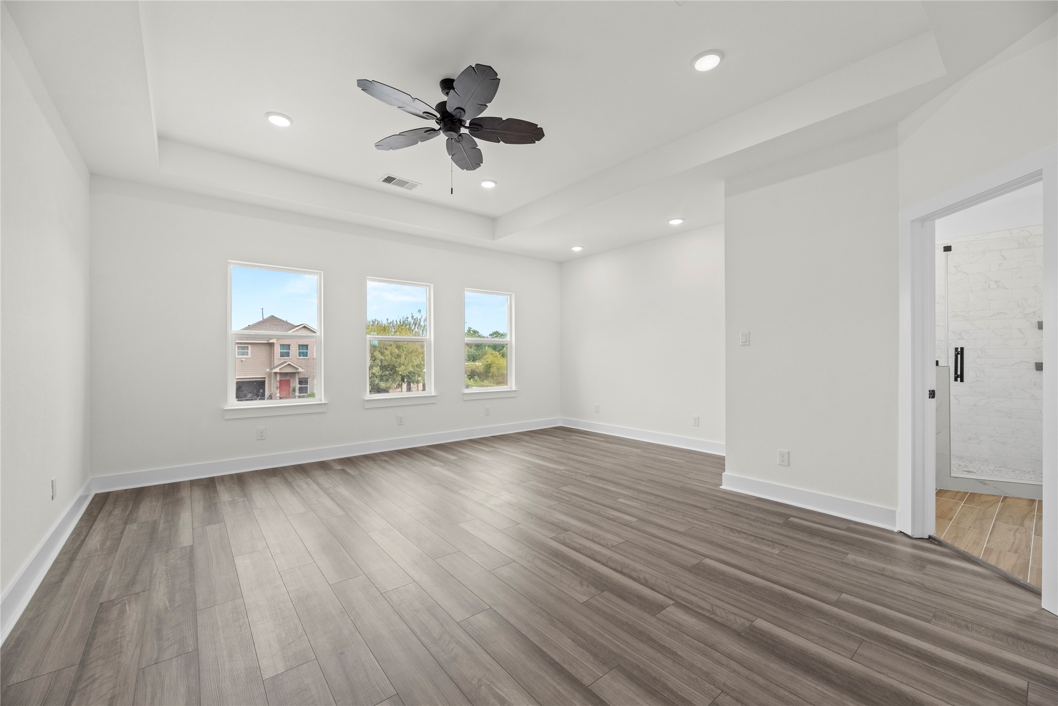 769 Marjorie Street Houston, TX 77088 - Photo 18 of 48 a view of an empty room with a window and wooden floor