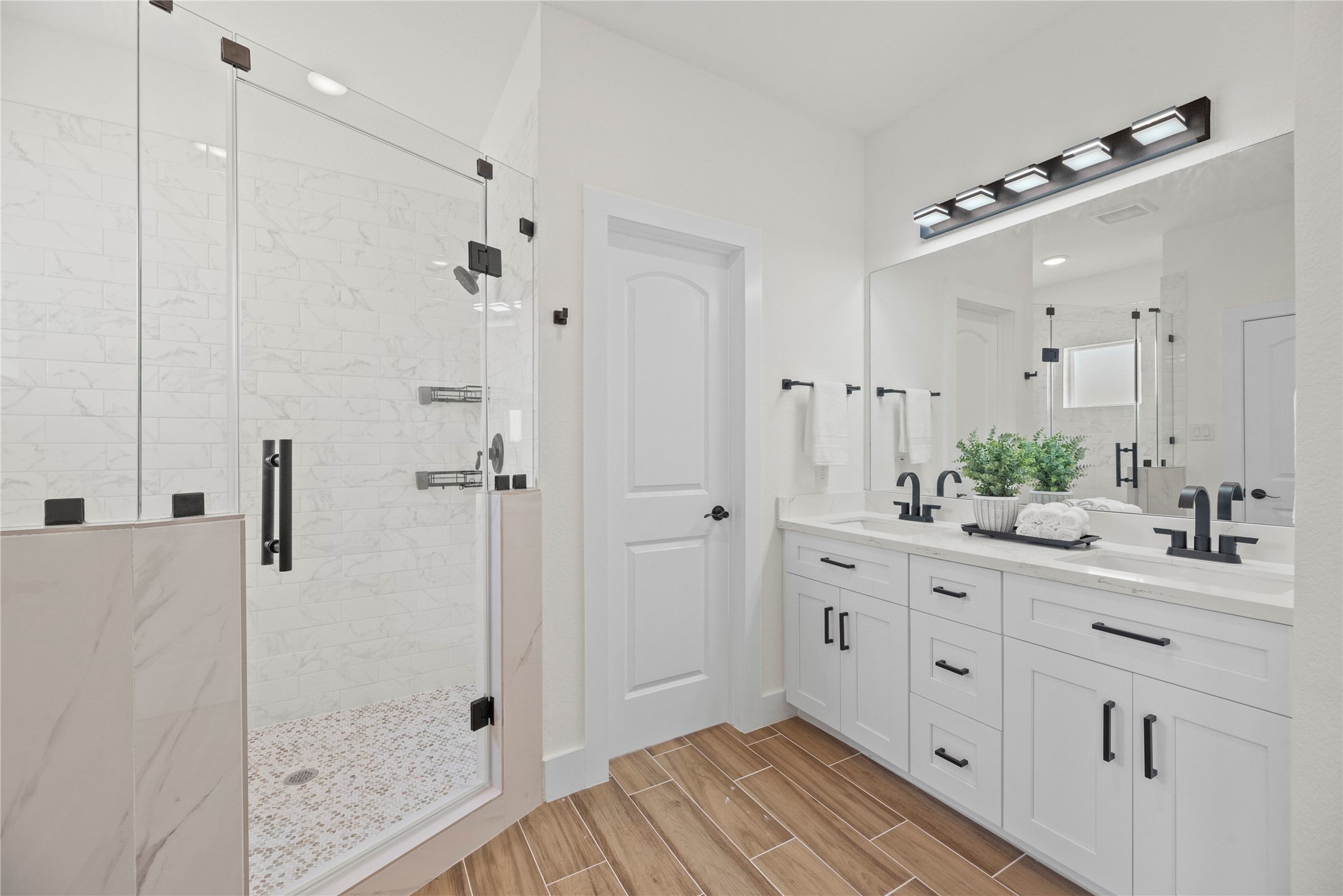 769 Marjorie Street Houston, TX 77088 - Photo 20 of 48 a spacious bathroom with a granite countertop sink mirror and shower