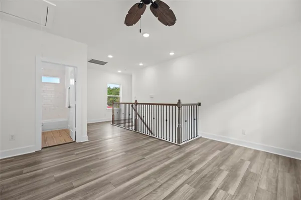 a view of a hallway view with wooden floor and staircase