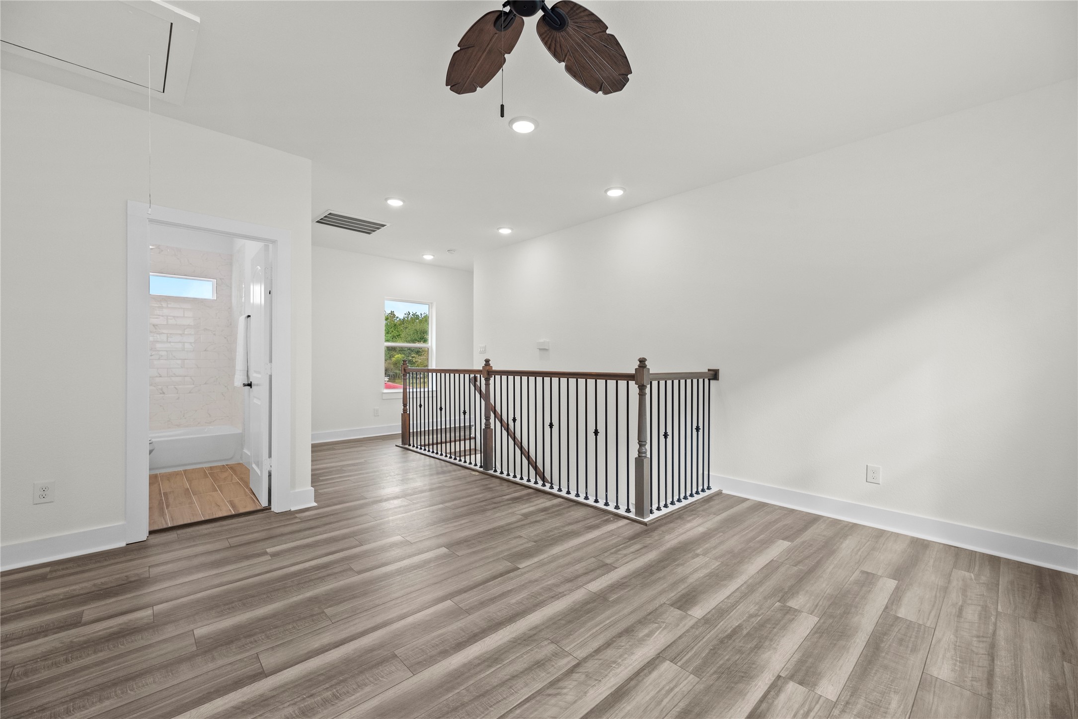 769 Marjorie Street Houston, TX 77088 - Photo 30 of 48 an empty room with wooden floor ceiling fan and window