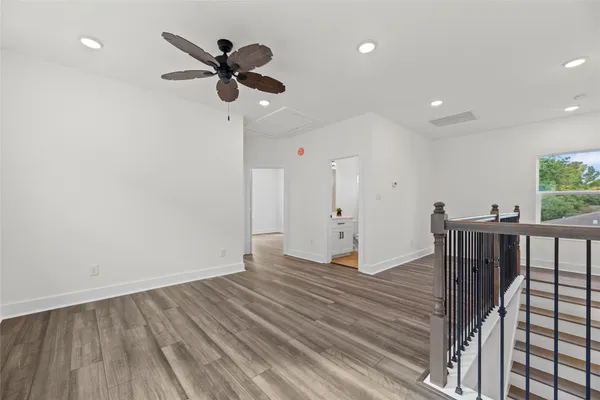 a view of a hallway with wooden floor and entryway