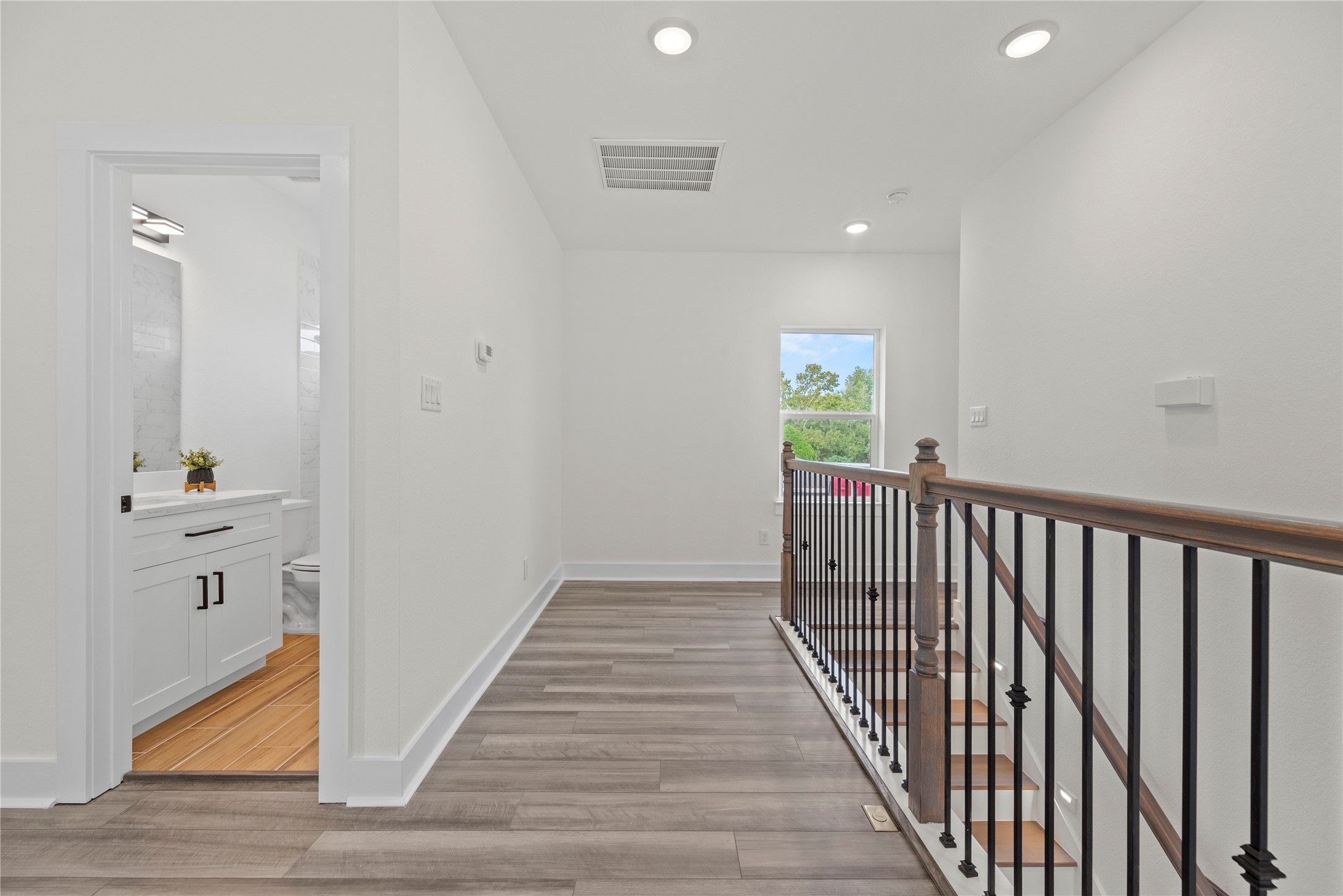 769 Marjorie Street Houston, TX 77088 - Photo 32 of 48 a view of a hallway view with wooden floor and staircase