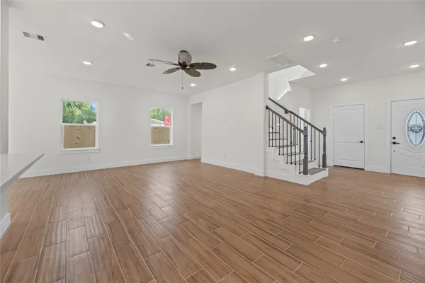 wooden floor in an empty room with a window