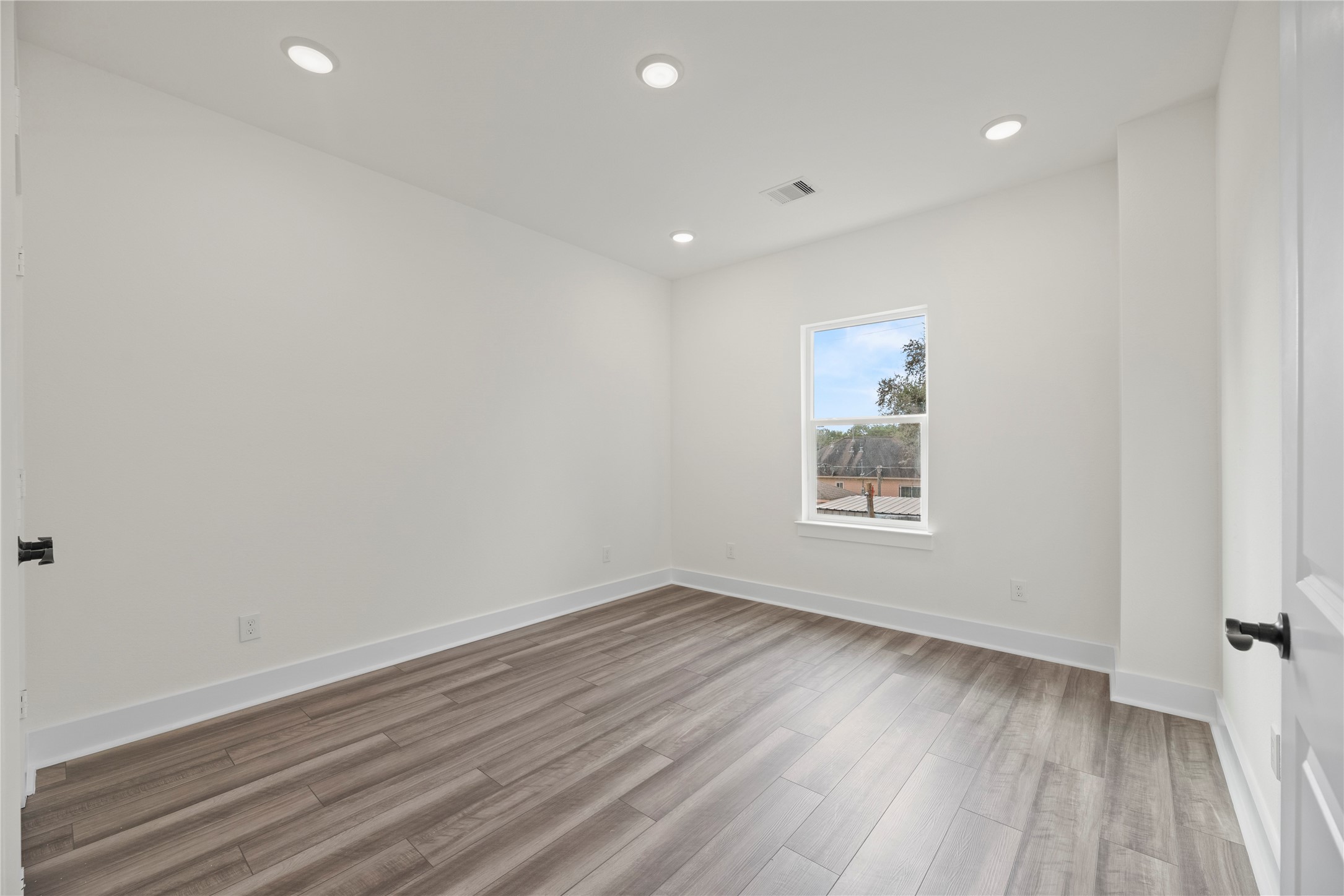 769 Marjorie Street Houston, TX 77088 - Photo 41 of 48 a view of an empty room with wooden floor and a window