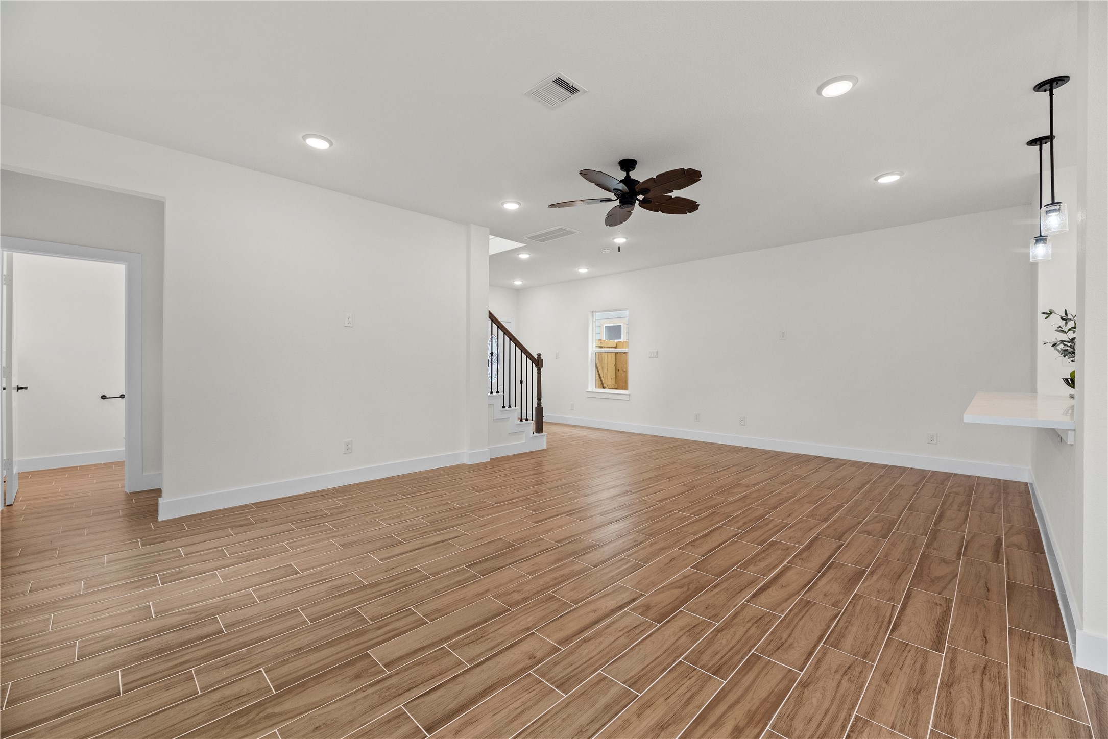 769 Marjorie Street Houston, TX 77088 - Photo 6 of 48 a view of an empty room with wooden floor and a ceiling fan
