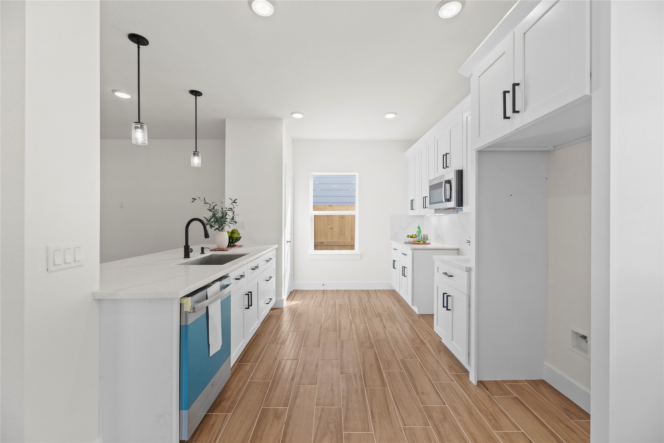 769 Marjorie Street Houston, TX 77088 - Photo 10 of 48 a kitchen with cabinets and wooden floor