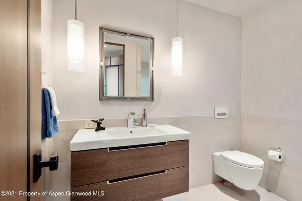 a bathroom with a sink toilet and mirror