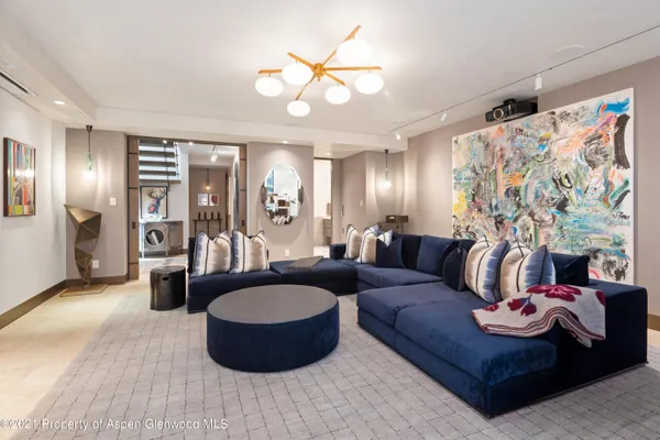 a living room with furniture and a chandelier
