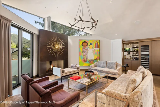 a living room with furniture a rug and a window