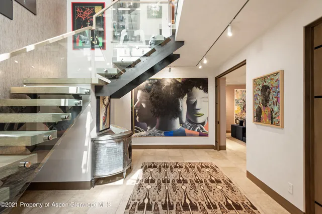 a view of staircase with a rug and a window