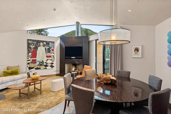 a living room with furniture a flat screen tv and kitchen view