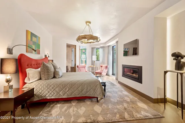 a bedroom with a bed and a fireplace