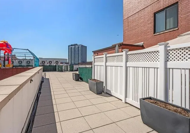 a terrace with outdoor seating and city view