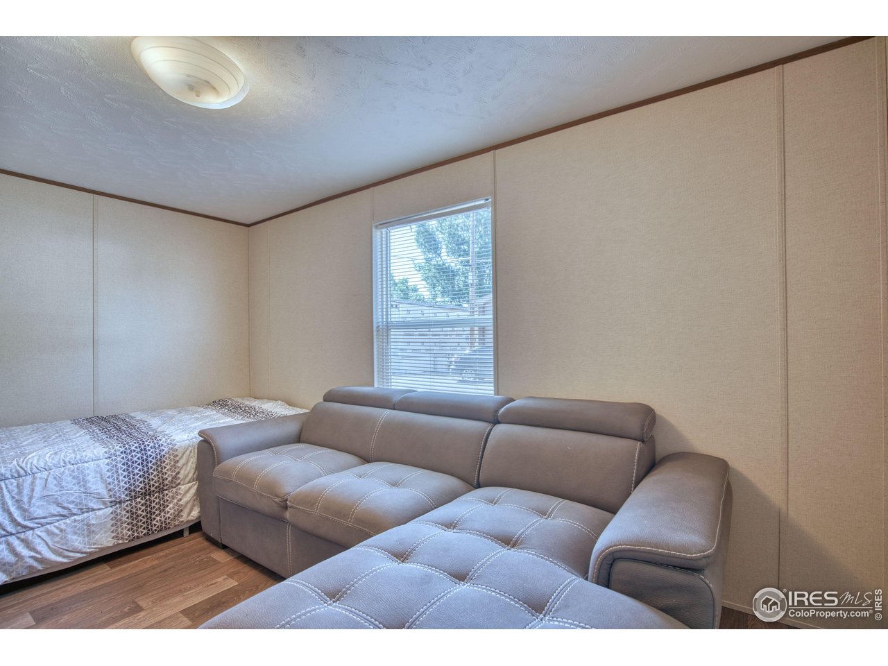 218 Grape Street, Unit 28 Hudson, CO 80642 - Photo 12 of 17 a living room with furniture and a window
