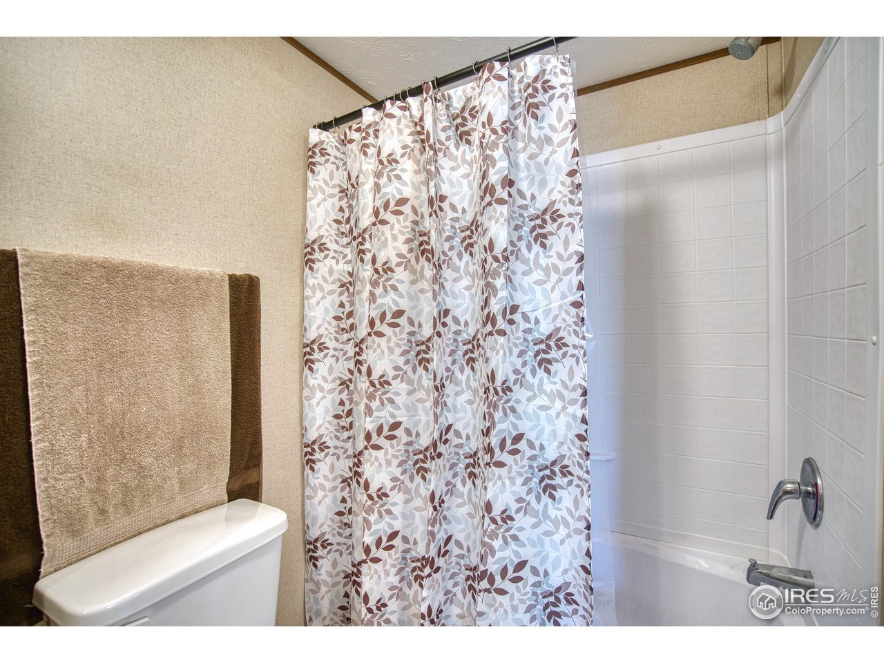218 Grape Street, Unit 28 Hudson, CO 80642 - Photo 13 of 17 a bathroom with a shower curtain and a window