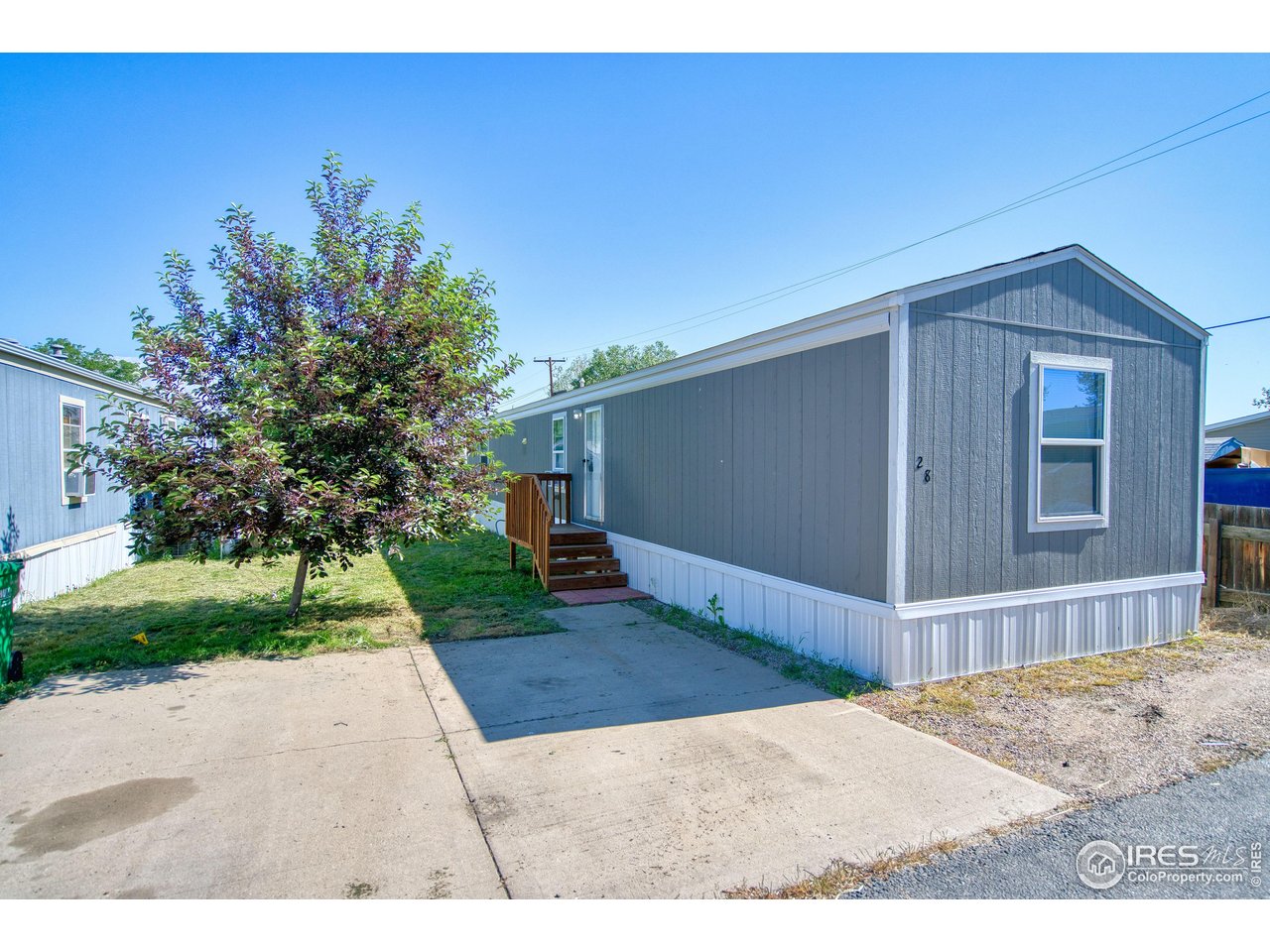 218 Grape Street, Unit 28 Hudson, CO 80642 - Photo 14 of 17 a front view of a house with a yard
