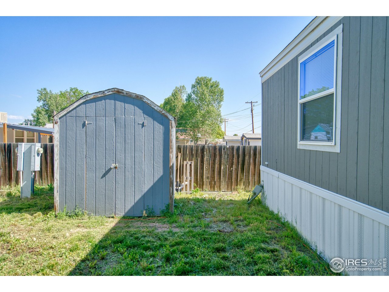 218 Grape Street, Unit 28 Hudson, CO 80642 - Photo 16 of 17 a view of backyard with garden and deck