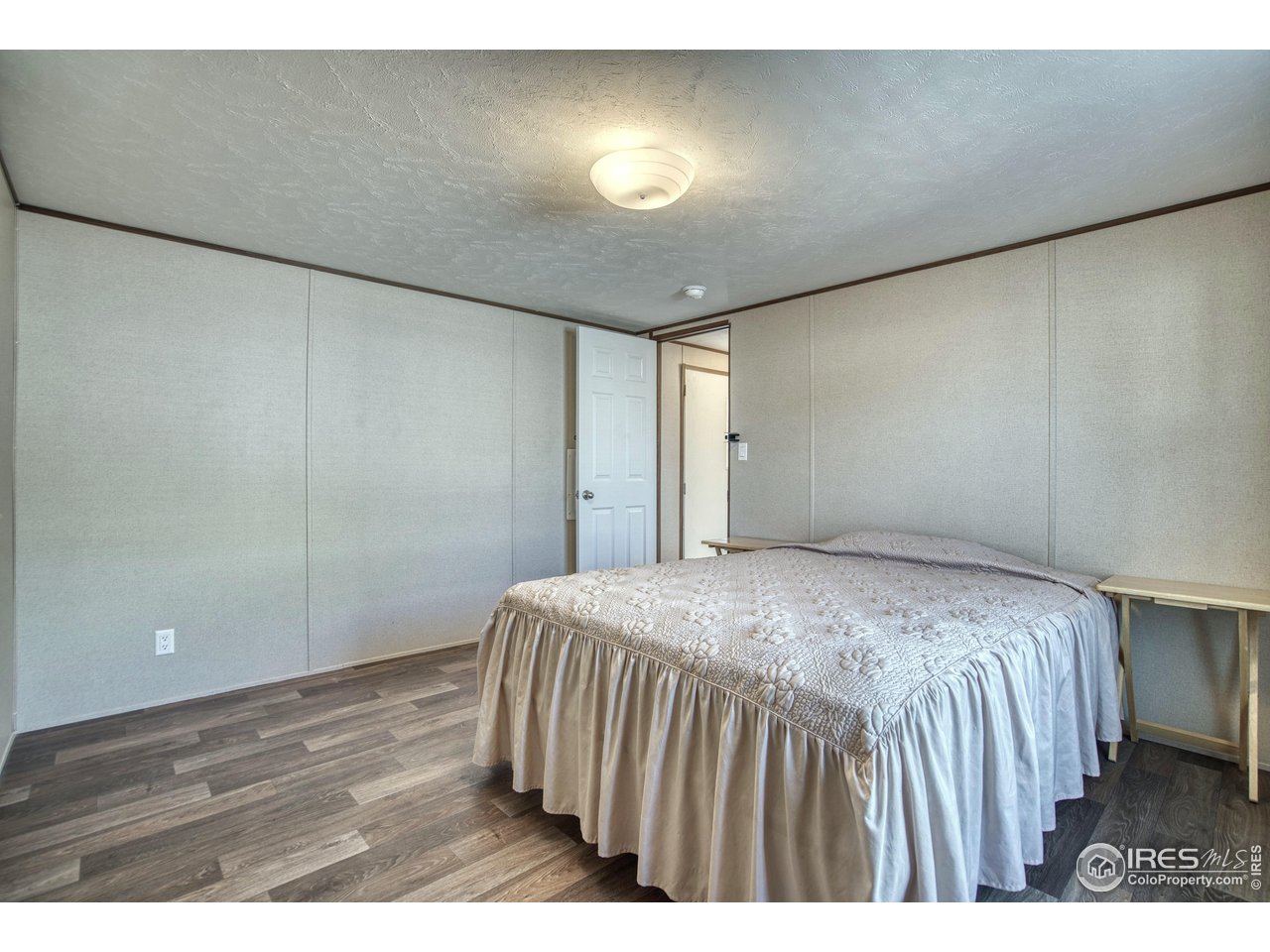 218 Grape Street, Unit 28 Hudson, CO 80642 - Photo 6 of 17 a bedroom with a bed and a table