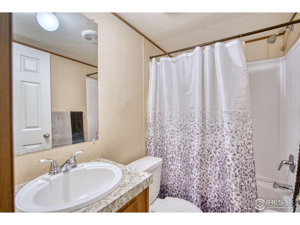 218 Grape Street, Unit 28 Hudson, CO 80642 - Photo 8 of 17 a bathroom with a sink and a mirror