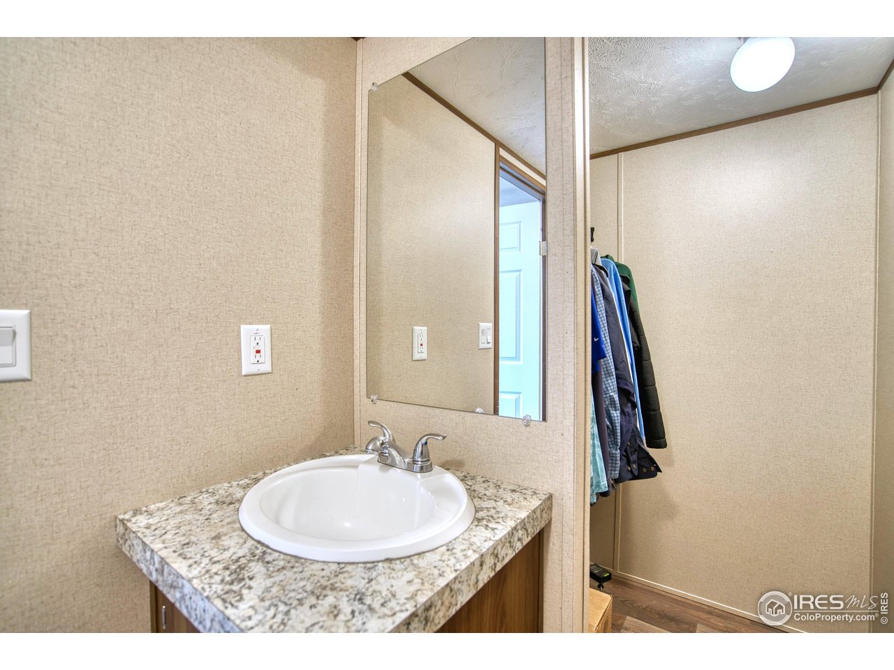 218 Grape Street, Unit 28 Hudson, CO 80642 - Photo 9 of 17 a bathroom with a sink and a mirror