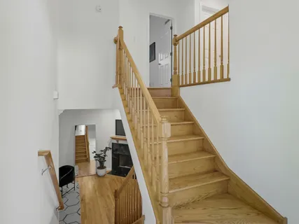 a view of entryway and hall with wooden floor